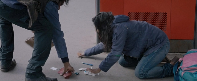 Wide shot frame from Dheepan — room, door, bag