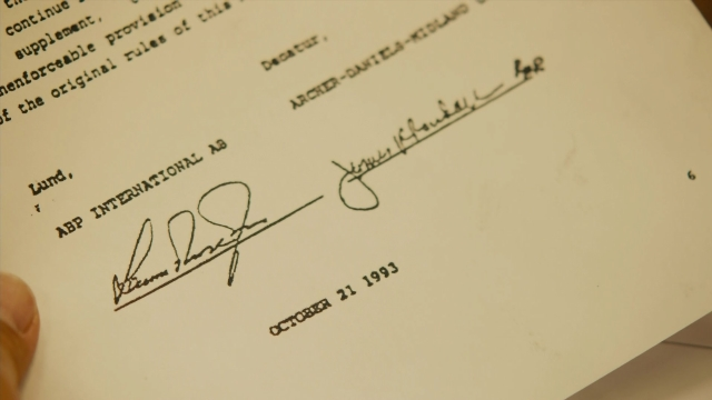 Frame from The Informant! — hand, envelope, person