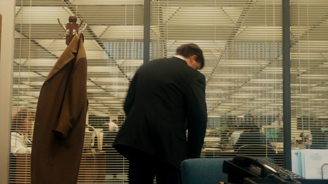 Frame from The Informant! — standing, coat, suit