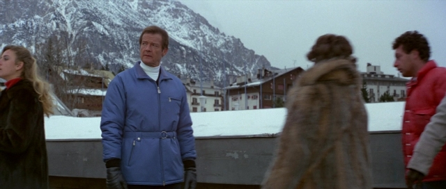 Wide shot frame from For Your Eyes Only — standing, dialogue, coat