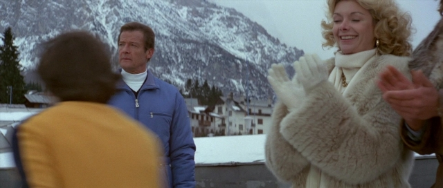 Wide shot frame from For Your Eyes Only — standing, dialogue, coat