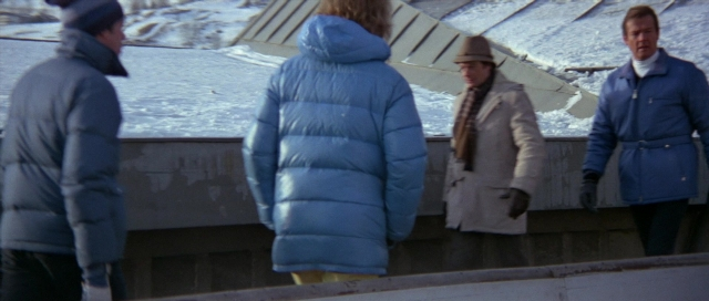 Wide shot frame from For Your Eyes Only — standing, hat, coat