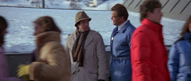 Wide shot frame from For Your Eyes Only — standing, dialogue, hat