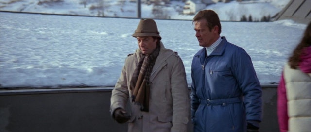 Wide shot frame from For Your Eyes Only — standing, hat, coat