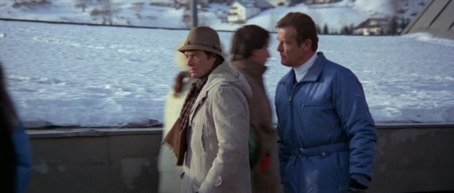 Wide shot frame from For Your Eyes Only — standing, dialogue, hat