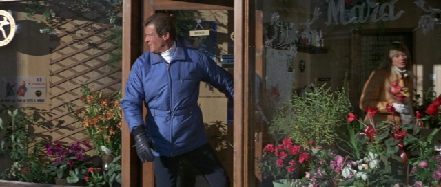 Wide shot frame from For Your Eyes Only — walking, door, coat