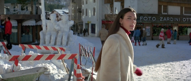 Wide shot frame from For Your Eyes Only — walking, street, coat