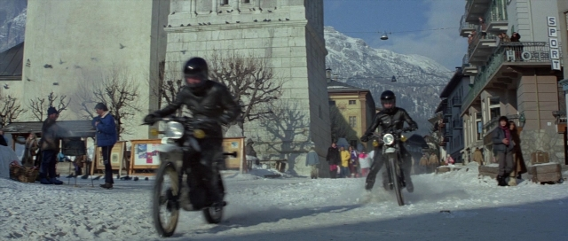 Wide shot frame from For Your Eyes Only — walking, street, bicycle