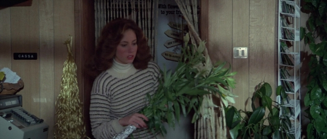 Wide shot frame from For Your Eyes Only — standing, room, hair