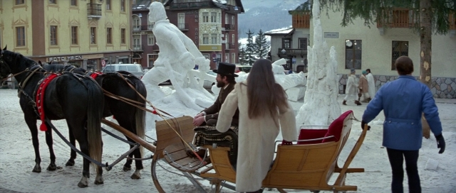 Wide shot frame from For Your Eyes Only — sitting, street, coat