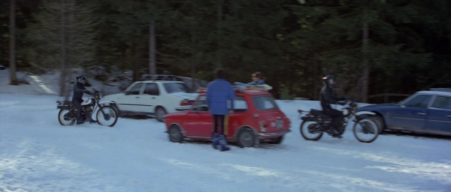 Wide shot frame from For Your Eyes Only — standing, street, car