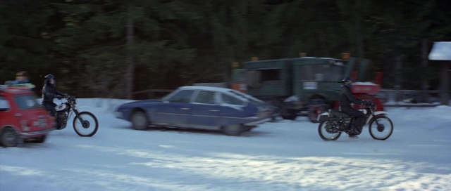 Wide shot frame from For Your Eyes Only — street, car, bicycle