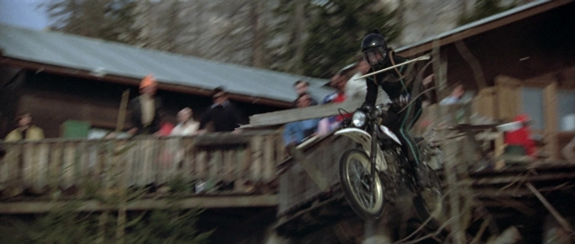 Wide shot frame from For Your Eyes Only — standing, hat, wheel