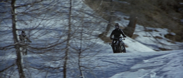 Wide shot frame from For Your Eyes Only — bicycle, snow, person