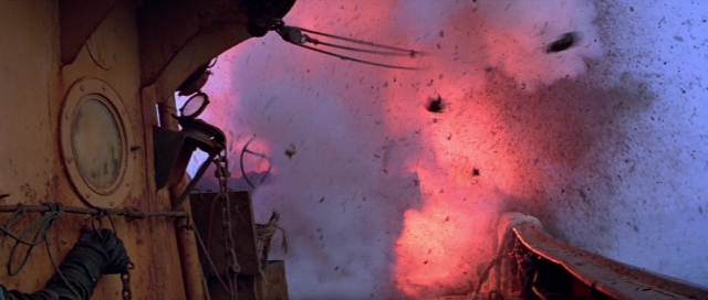 Wide shot frame from For Your Eyes Only — fire, water, boat