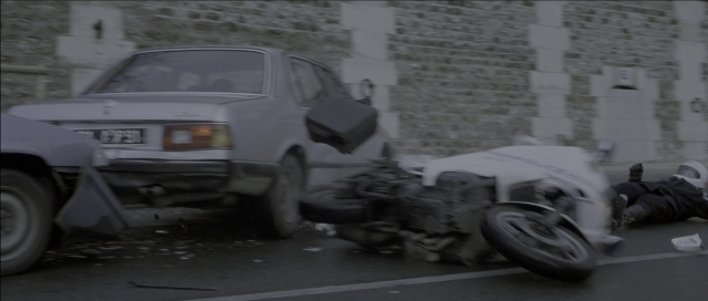 Wide shot frame from The Bourne Identity — plate, street, car