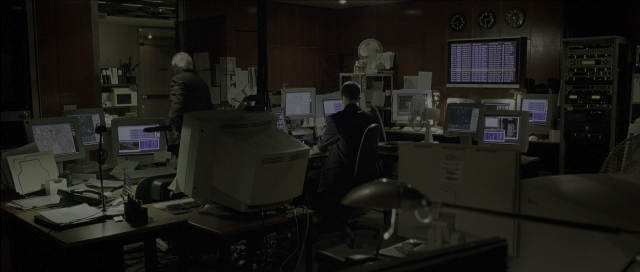 Wide shot frame from The Bourne Identity — sitting, room, lamp