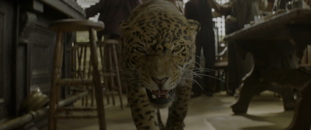 Wide shot frame from Jungle Cruise — walking, room, table