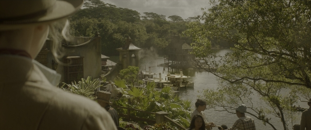 Wide shot frame from Jungle Cruise — standing, dialogue, water