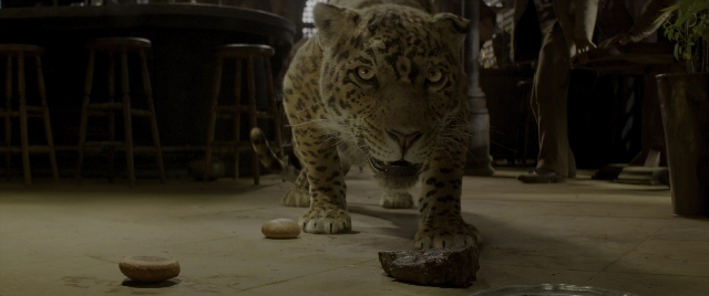 Wide shot frame from Jungle Cruise — walking, room, table