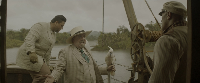 Wide shot frame from Jungle Cruise — standing, dialogue, hat