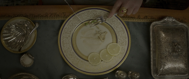 Wide shot frame from Jungle Cruise — plate, table, hand