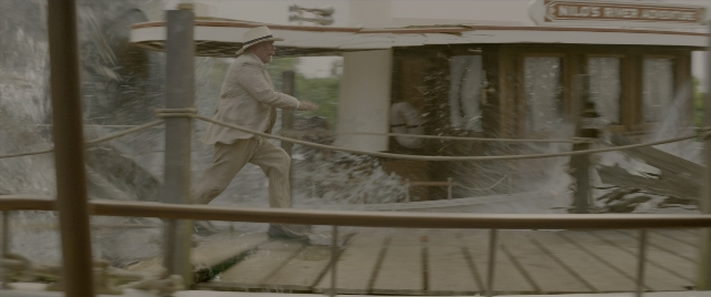 Wide shot frame from Jungle Cruise — walking, hat, suit