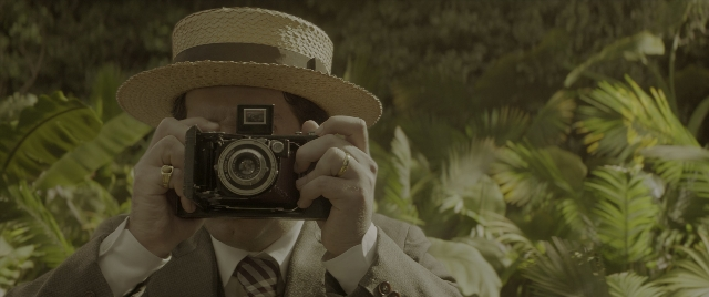 Wide shot frame from Jungle Cruise — hat, suit, tie
