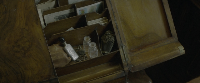 Wide shot frame from Jungle Cruise — bottle, glass, furniture