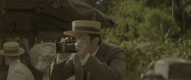 Wide shot frame from Jungle Cruise — standing, hat, suit
