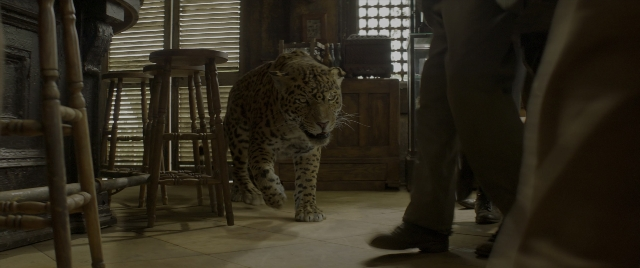 Wide shot frame from Jungle Cruise — walking, room, table