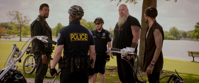 Wide shot frame from 21 Jump Street — standing, hat, bicycle