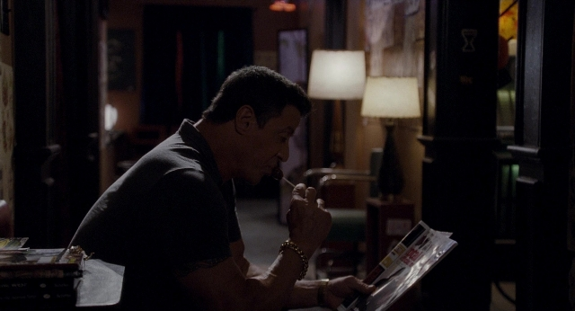 Frame from Bullet to the Head — sitting, room, table