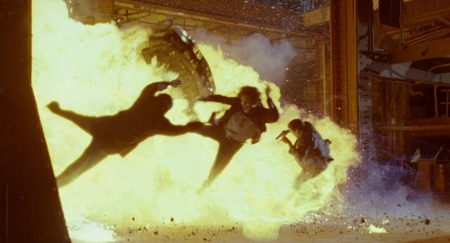 Wide shot frame from Bullet to the Head — smoke, person