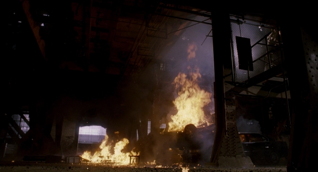 Wide shot frame from Bullet to the Head — fire, car, smoke