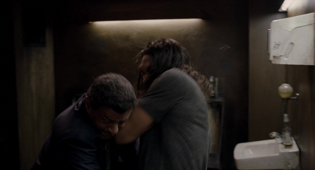Wide shot frame from Bullet to the Head — standing, mirror, bathroom