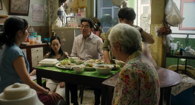 Wide shot frame from Lahn Mah — table, kitchen, food