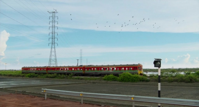 Frame from Lahn Mah — train, bird, traffic light