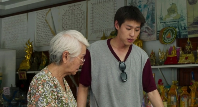 Wide shot frame from Lahn Mah — standing, room, dialogue