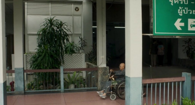 Wide shot frame from Lahn Mah — walking, door, house