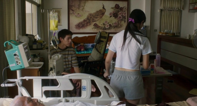 Wide shot frame from Lahn Mah — standing, room, bed