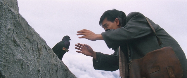 Frame from Zhong hua zhan shi — standing, face, bag