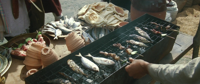 Wide shot frame from Zhong hua zhan shi — hand, fish, person