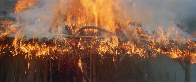 Wide shot frame from Zhong hua zhan shi — fire, night, smoke