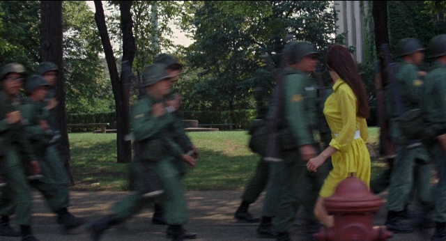 Medium shot frame from Medium Cool — walking, street, fire