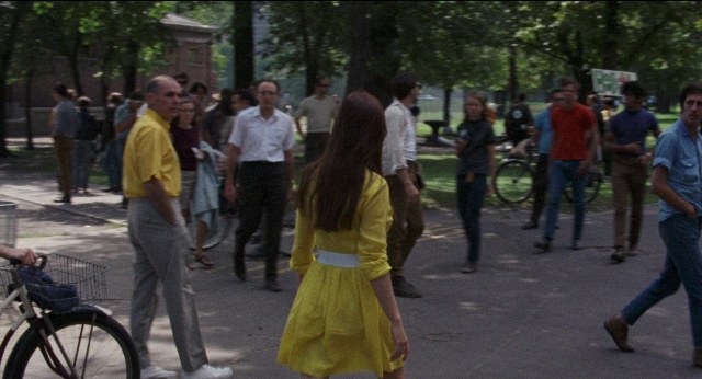 Wide shot frame from Medium Cool — walking, street, dress