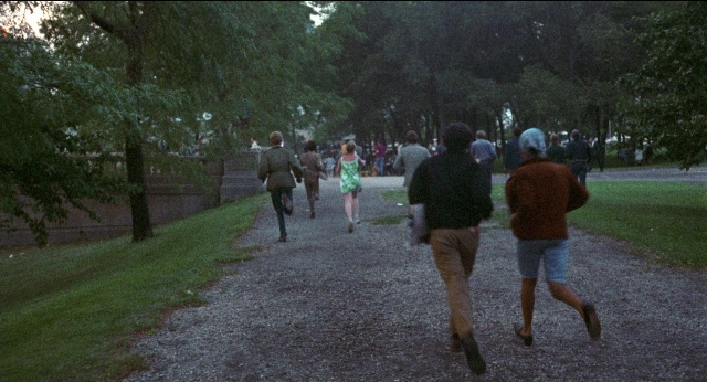 Wide shot frame from Medium Cool — walking, person, footwear