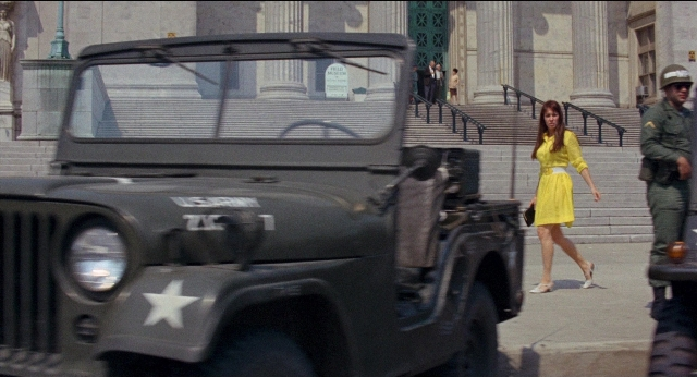 Wide shot frame from Medium Cool — standing, walking, street