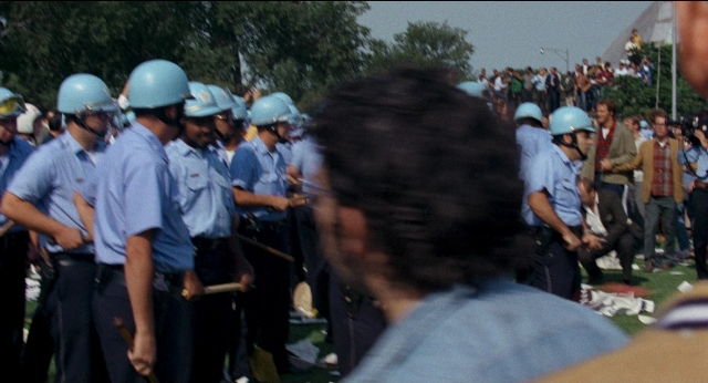 Medium shot frame from Medium Cool — standing, person, human face