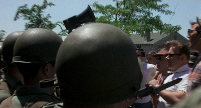Frame from Medium Cool — standing, dialogue, shirt